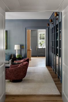 a living room with blue walls and wooden floors