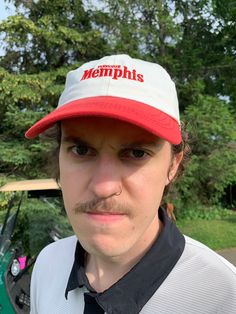 a man wearing a red and white hat with the word memphits on it