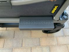 a close up view of the front end of a grey and black rolling luggage cart