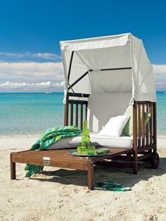 an umbrella is set up on the beach to shade it from the sun and relax