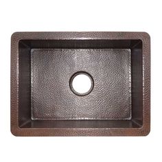 a square brown sink with an oval hole in the center