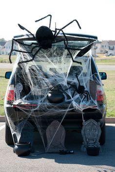 a car decorated with spider webs and decorations