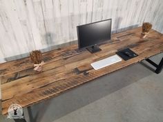 a desk with a computer monitor and keyboard on it