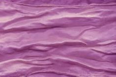 a purple sheet that is laying on the ground