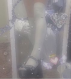 a woman's legs and shoes are shown through a glass door with chains on them