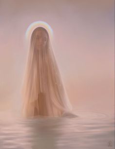 a woman is floating in the water wearing a veil