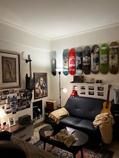 a living room filled with furniture and lots of skateboards on the wall above it