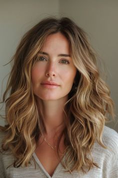 Medium length wavy hairstyles provide versatility and an effortlessly chic appearance. Click for more inspiration. Full Curls For Medium Length Hair, Mid Length Hair Wavy Curly, Mid Length Hairstyles For Wavy Hair, Loose Perms For Medium Length Hair, Medium Wavy Layers Haircut, Blowout Hairstyles Medium Length, Mid Length Wavy Hairstyles For Women, Medium Haircut Wavy, Medium Hair Cuts Wavy