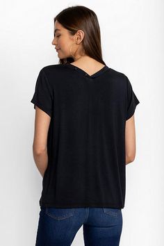 Crafted from a super soft modal blend with a hint of stretch, the Modal Jersey Button Neck Tee offers a modern take on classic sportswear. Featuring a curved V-neckline with decorative buttons, this short sleeve tee creates a relaxed fit with a custom feel. Pair with linen shorts and fashion sneakers to take on the warmest days. Johnny Was Women's Modal Jersey Button Neck T-Shirt in Black Beauty White, Size Small, Linen Versatile Black Loungewear Tops, Casual Modal T-shirt, Versatile Viscose Tops For Loungewear, Casual Modal Top With Relaxed Fit, Casual Modal Tops For Loungewear, Black Modal Tops For Summer, Everyday Black Tops With Shirttail Hem, Black Everyday Tops With Shirttail Hem, Casual Crew Neck Top In Viscose