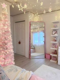 a bedroom decorated for christmas with pink and white decorations