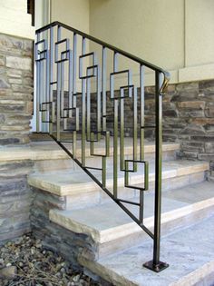 a metal stair rail with wood spindles and custom metal rails on the bottom handrail