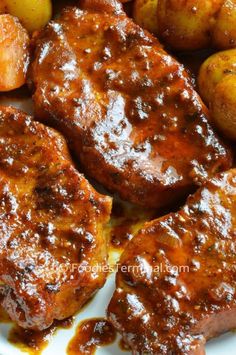 some meat and potatoes on a white plate