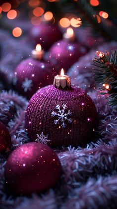 purple christmas ornaments with white snowflakes and lights in the background, surrounded by evergreen branches