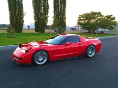 a red sports car is parked on the street