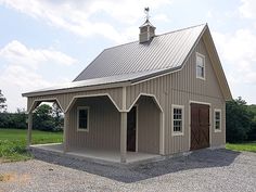 a two story barn with a covered porch