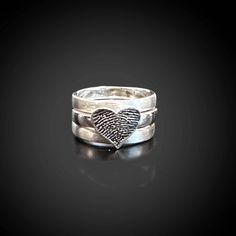 "Handmade sterling silver fingerprint ring.   Wide and thick, three (3) stack ring.  Each band is sterling silver and approximately 3 mm wide and 1.5 mm thick.  Overall width of ring with all 3 stacks is approximately 10 mm.   The sterling silver custom heart fingerprint is approximately 3/8\"    The inner band has a shiny finish and the 2 outer bands have a satin finish for great contrast.   OPTIONS:  You can choose to have a dark patina applied to highlight the recessed areas of the fingerprin Stacked Sterling Silver Jewelry For Anniversary, Sterling Silver Stacked Jewelry For Anniversary, Stacked Sterling Silver Rings, Anniversary Sterling Silver Stacked Jewelry, Stacked Sterling Silver Rings In Silver, Anniversary Stacked Sterling Silver Jewelry, Stacked Silver Jewelry For Anniversary, Silver Stacked Jewelry For Anniversary, Heart Fingerprint