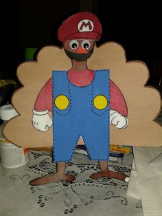 a paper cut out of a man wearing overalls and a hat