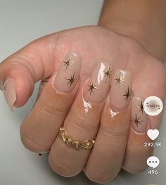 a woman's hand with pink and gold nail polish