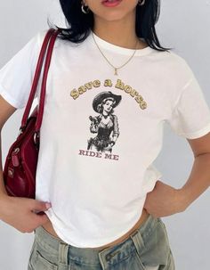 Save a Horse Ride Me Cowgirl Cowboy baby tee y2k baby tee crop top trendy baby tee festival outfit inappropriate shirt 90s tee vintage  Important: To achieve the Baby Tee look, we use Youth size heavy cotton Gildan 5000B tees. BEFORE ORDERING PLEASE MAKE SURE TO CHECK YOUR MEASUREMENTS.   Heavy Cotton Baby Tee Composition: Solid colors, 100% cotton Sport Grey - 90% cotton, 10% polyester The shoulders have twill tape for improved durability Ribbed knit highly elastic collar with seam helps retain its shape No side seams 💕 Care Instructions Machine wash: Warm (max 40oC or 105oF). No bleach, please! But tumble dry on medium heat. Iron, steam, or dry on low heat for that wrinkle-free look! No dry cleaning! 🎨 Our designs are printed using the highest quality professional direct-to-garment (DT Inappropriate Shirts, Cowboy Baby, 90s Tees, Baby Tees Y2k, Cowgirl Cowboy, Y2k Baby Tee, Baby Cowboy, Cropped Tops, Cropped Tube Top