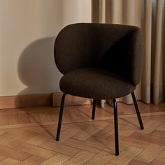 a brown chair sitting on top of a wooden floor