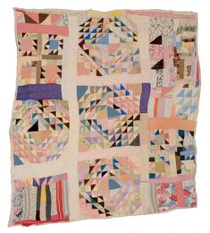 a multicolored patchwork quilt is displayed on a white background