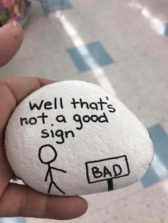 a hand holding a rock with the words well that's not a good sign on it