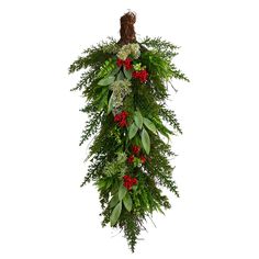 a christmas wreath hanging from the ceiling with red berries and greenery on it's sides