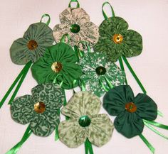 several green and white flowers with ribbons on them