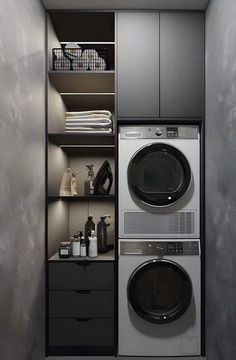 a washer and dryer in a small room with shelves on the wall behind them