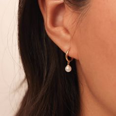 Dainty Pearl Drop Hoop Earrings ◇ Earrings measures approx.:       Hoop - Outer diameter: 10mm / Inner diameter: 8mm      Charm: 6mm (hand forged earrings vary slightly) ◇ These earrings are sold as pair. ◇ These earrings will arrive in an eco-friendly jewelry paper box, making it a nice gift to give a friend or keep for yourself. ◆ View more EARRINGS https://www.etsy.com/shop/eplusfjewelry?section_id=13190709 ◆ View ALL ITEMS https://www.etsy.com/shop/EFHANDMADEJEWELRY shop policies: https://www.etsy.com/your/shops/EFHANDMADEJEWELRY/policies All designs, images & text copyright ©2023 EFHANDMADEJEWELRY Do not copy any designs and content from our shop. خواتم خطوبة, Earrings Gold Pearl, Drop Hoop Earrings, Reflecting Light, Gold Pearl Earrings, Classy Jewelry, Party Earrings, Gold Earrings Designs, Jewelry Lookbook