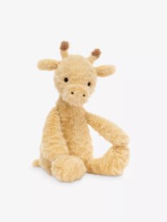 a stuffed giraffe sitting on the ground with it's legs spread out