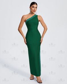 a woman in a green dress posing for the camera with her hands on her hips