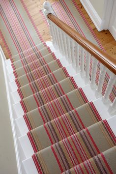 the stairs are lined with striped carpet