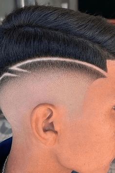 This high fade haircut has a noticeable difference with its clear, accurate cuts that thin gradually from a really short size at the edges up to a thicker, textured top. The design is emphasized by a shaped line that includes a trendy, current characteristic to the traditional fade. It's a brave choice for somebody hoping to - Click to see more of Upgrade Your Look with These 28 Stylish High Fade Haircuts for Men and follow us for more hairstyle ideas. // Photo Credit: Instagram @barbeiro_dicas Hair Tattoo Men, Fade Mohawk, Hair Tattoo Designs, Side Haircut, Haircut Designs For Men, Fade Haircut Designs, Hair Designs For Men, Shaved Designs, Barber Haircuts