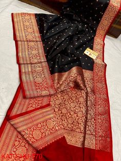 Extremely beautiful Pure katan Benarasi saree .Deep zed black body with red zariwoven border.Rich handcrafted zari work on border and pallu.Alloverbody has zari weaving polka dots. Saree is very pretty, light weight, with elegant look,silk quality is just awesome. Surely you will fall in love with the quality and texture of the saree when you get it on your hand. Saree has contrast BP. Best suited for weeding, party,puja,gifting. As the saree is completely handcrafted and will be made to order , Black Katan Silk Dupatta With Zari Work, Festive Black Katan Silk Dupatta, Elegant Black Dupatta With Zari Weaving, Black Katan Silk Dupatta For Wedding, Black Saree With Zari Weaving For Wedding, Elegant Black Banarasi Silk Dupatta, Black Katan Silk Saree For Wedding, Black Katan Silk Saree With Cutdana, Black Katan Silk Saree With Cutdana Details