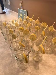 several mason jars filled with lemons and toothpicks on top of a table