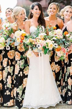 a group of women standing next to each other holding bouquets