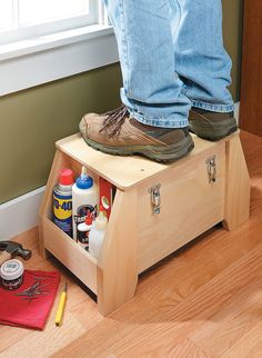 a person standing on top of a wooden box next to a pair of shoes and tools