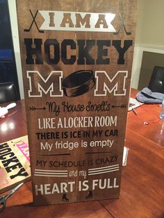 a wooden sign that says i am a hockey mom