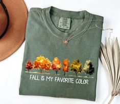 Comfort Colors® Fall Tree Shirt, Thanksgiving Shirt, Autumn Tree Line Shirt, Fall Autumn Women's Shirt, Trendy Bestseller Comfort Fall Shirt ⭐️ Welcome to FlyaWay Trend Store ⭐️ Our products are BELLA+CANVAS and for Sweatshirts GILDAN quality ✨ FREE SHIPPING is for orders 35 usd and over. Enjoy 30 % OFF SALE! Please contact me for bulk (+10) orders. If you have any problems or questions, please contact me and I will be here to help. NO RETURNS OR EXCHANGES ON SHIRTS/CLOTHING ITEMS. FIT AND SIZIN Green Graphic Print Shirt For Fall, Fall Is My Favorite Color, Fall Tree, Autumn Tree, Thanksgiving Shirt, My Favorite Color, Tree Shirt, Tree Line, Fall Shirt