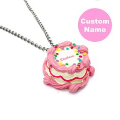 "This Happy Birthday Necklace is a perfect handmade cute charm jewelry birthday gift for your best friend or any woman in your life! Perfectly pink and kawaii, this cake pendant is made from resin and features a high quality gold finish stainless steel chain. This is a custom name necklace, with your chosen name on top of the cake in pink cursive style lettering. Includes free pink and holographic logo gift box to celebrate your favorite friend or loved one. Style & Personalized Initial: -Cake h Fun Charm Necklaces For Gifts, Sweet Pink Necklaces For Valentine's Day, Playful Charms Jewelry For Birthday, Personalized Pink Necklace For Valentine's Day, Pink Necklace For Valentine's Day Personalized Gift, Sweet Pink Necklace For Valentine's Day, Cute Charm Necklaces For Birthday, Personalized Kawaii Jewelry For Birthday, Fun Pink Charm Necklaces