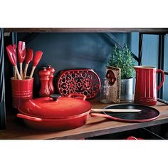 red dishes and utensils on a wooden table