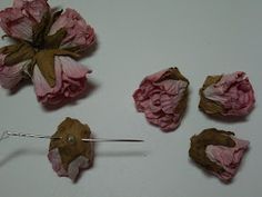 several pieces of pink flowers are being used to make hair clips