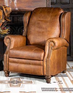 a brown leather recliner chair sitting on top of a rug