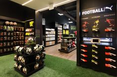 the inside of a soccer store filled with balls