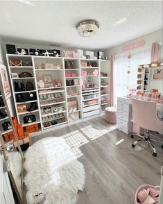 a room filled with lots of white shelves and shoes on top of wooden flooring