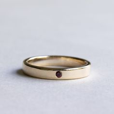 Plain and simple wear-it-every-day band with ruby. Metal: 14k Solid Gold Available in White gold, rose gold and yellow gold. Setting Type: Flush Stone: 2mm ruby Dimension: 3mm band width Engraving available. Final sale for personalized ring. FREE SHIPPING USA- All of our jewelry will arrive in custom packaging ready for gift giving. CARE: To prolong the color and shine of your jewelry, avoid contact with perfume, lotion, and water. Store in a bag or jewelry box. SATISFACTION GUARANTEED All piece Minimalist Yellow Gold Ruby Ring For Formal Occasion, Classic Stackable Ruby Ring With Round Band, 14k Gold Ruby Ring With Polished Finish For Wedding, Minimalist 14k Yellow Gold Ruby Ring, Classic Ruby Stackable Rings In Yellow Gold, Ruby Ring With Polished Finish In 14k Gold, Minimalist Stackable Ruby Ring In Yellow Gold, Classic Yellow Gold Ruby Stackable Rings, Ruby Ring With Polished Finish And Round Band