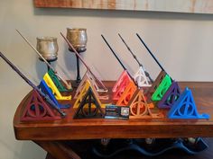 a wooden table topped with harry potter's houses and wands on top of it