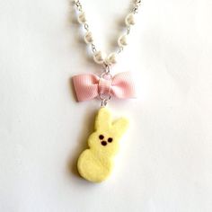 These necklaces are so adorable and realistic, perfect for Easter or the entire Spring season. I handmade these super cute marshmallow bunnies from polymer clay and added a realistic sugar-like texture. These bunnies come in your choice of a classic pastel color: white, pink, yellow, blue, or purple. Each bunny is about 1.25" tall and comes on a silver plated chain accented with glass pearls and a pink bow,  18" long.**Made to order - may take up to 2 weeks to make before shipment**Every order c Handmade White Kawaii Necklace, Cute Handmade Easter Jewelry, Cute Yellow Necklace For Gift, Cute Yellow Necklace For Gifts, Marshmallow Bunnies, Easter Necklace, Marshmallow Bunny, Cute Marshmallows, Kawaii Necklace