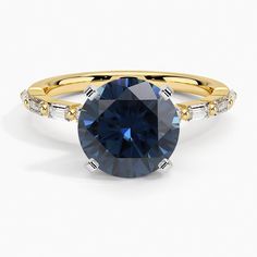 a yellow gold ring with a blue sapphire and diamonds